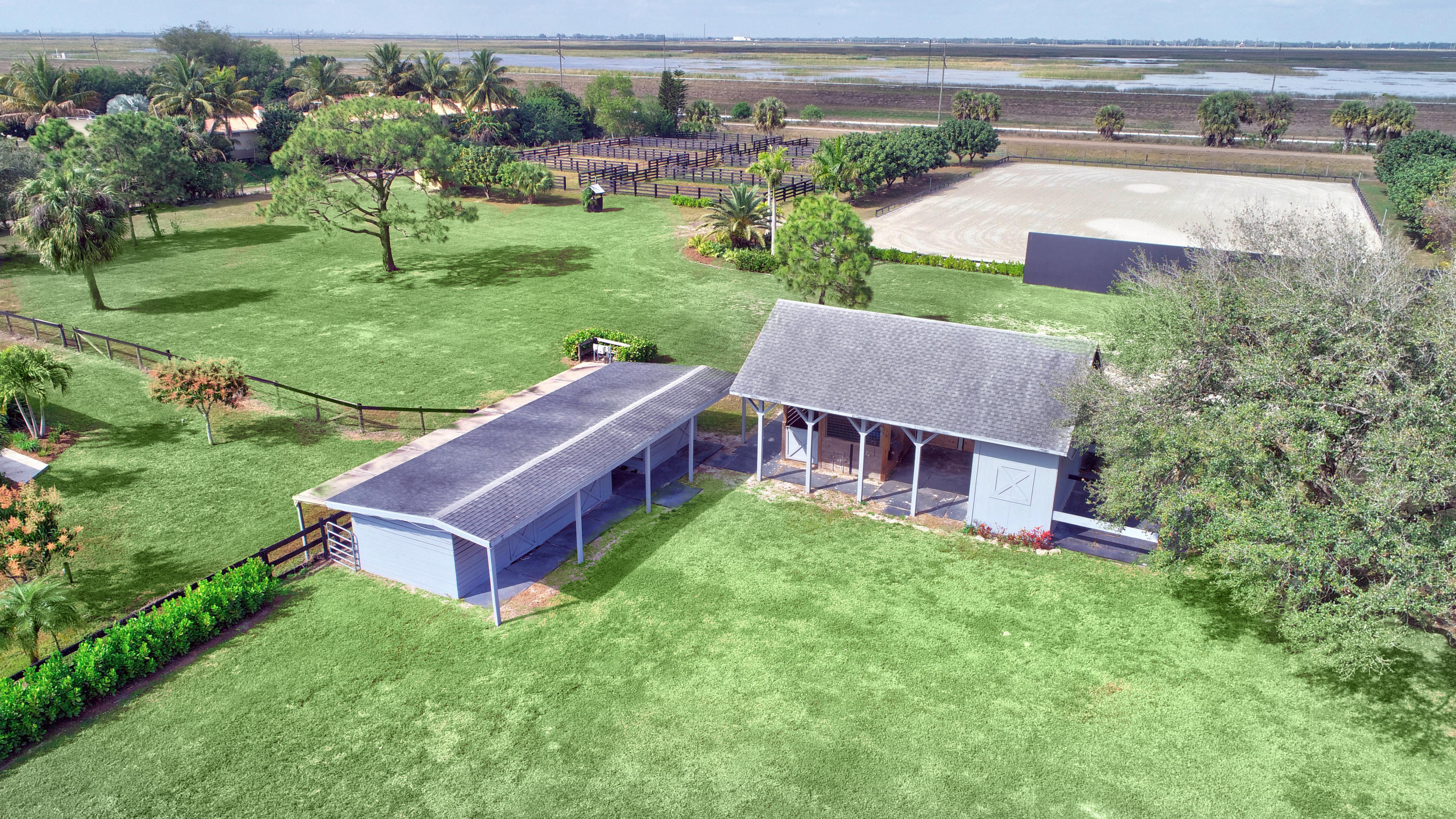 16493 Rustic Road Wellington, FL 33470 - Photo 36 of 57 a view of a house with a big yard plants and large trees
