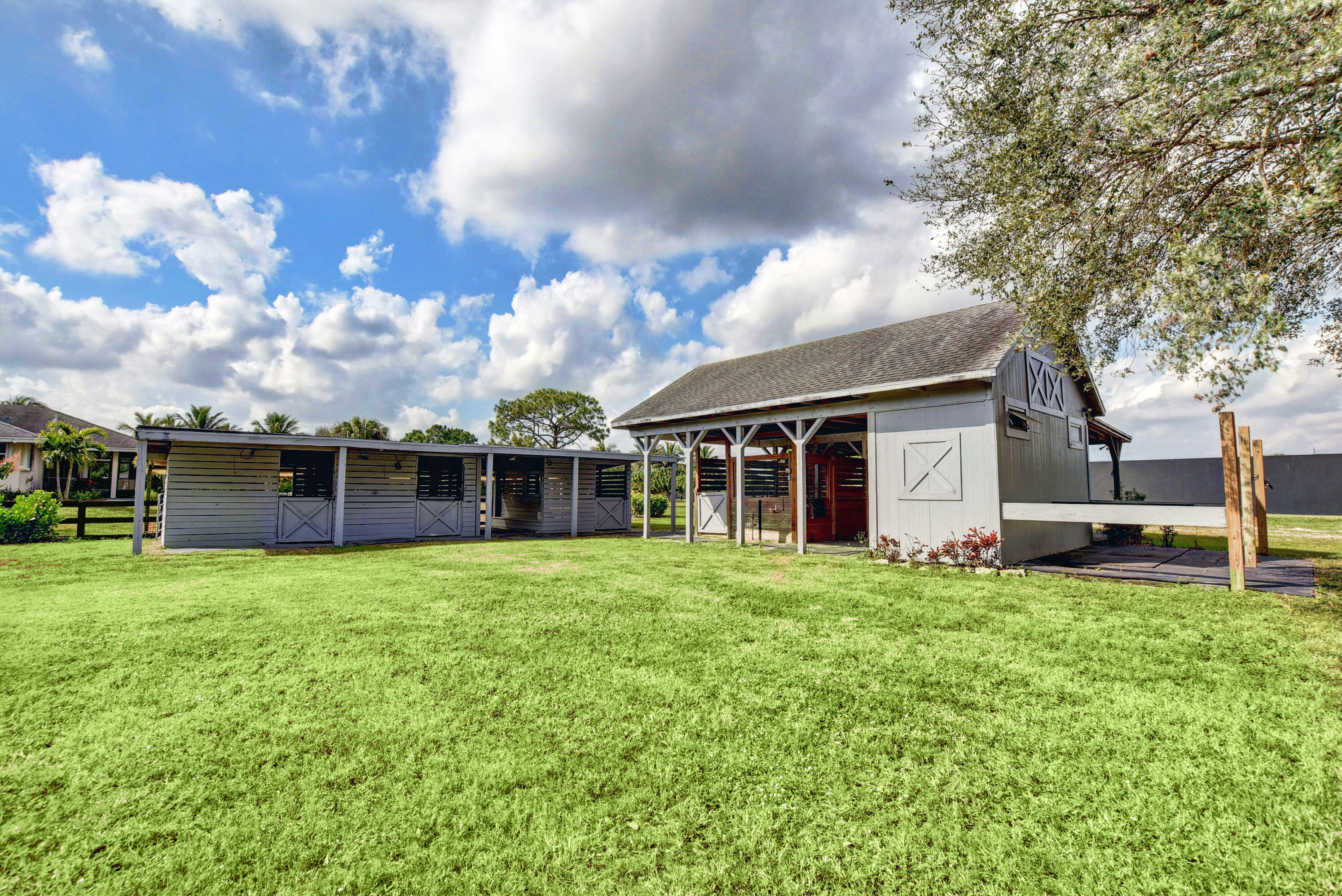 16493 Rustic Road Wellington, FL 33470 - Photo 42 of 57 a view of a house with a yard and sitting area