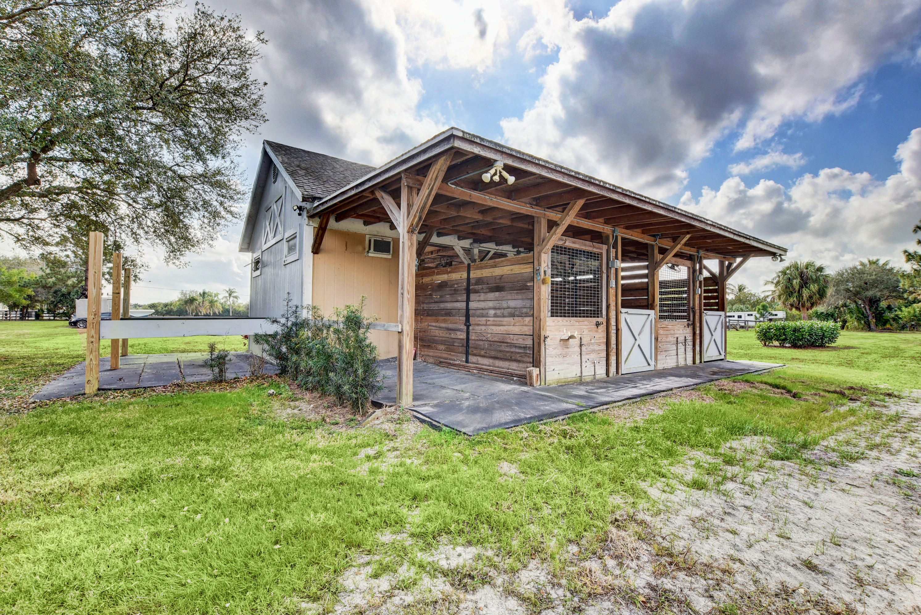 16493 Rustic Road Wellington, FL 33470 - Photo 44 of 57 a view of a house with a yard and sitting area