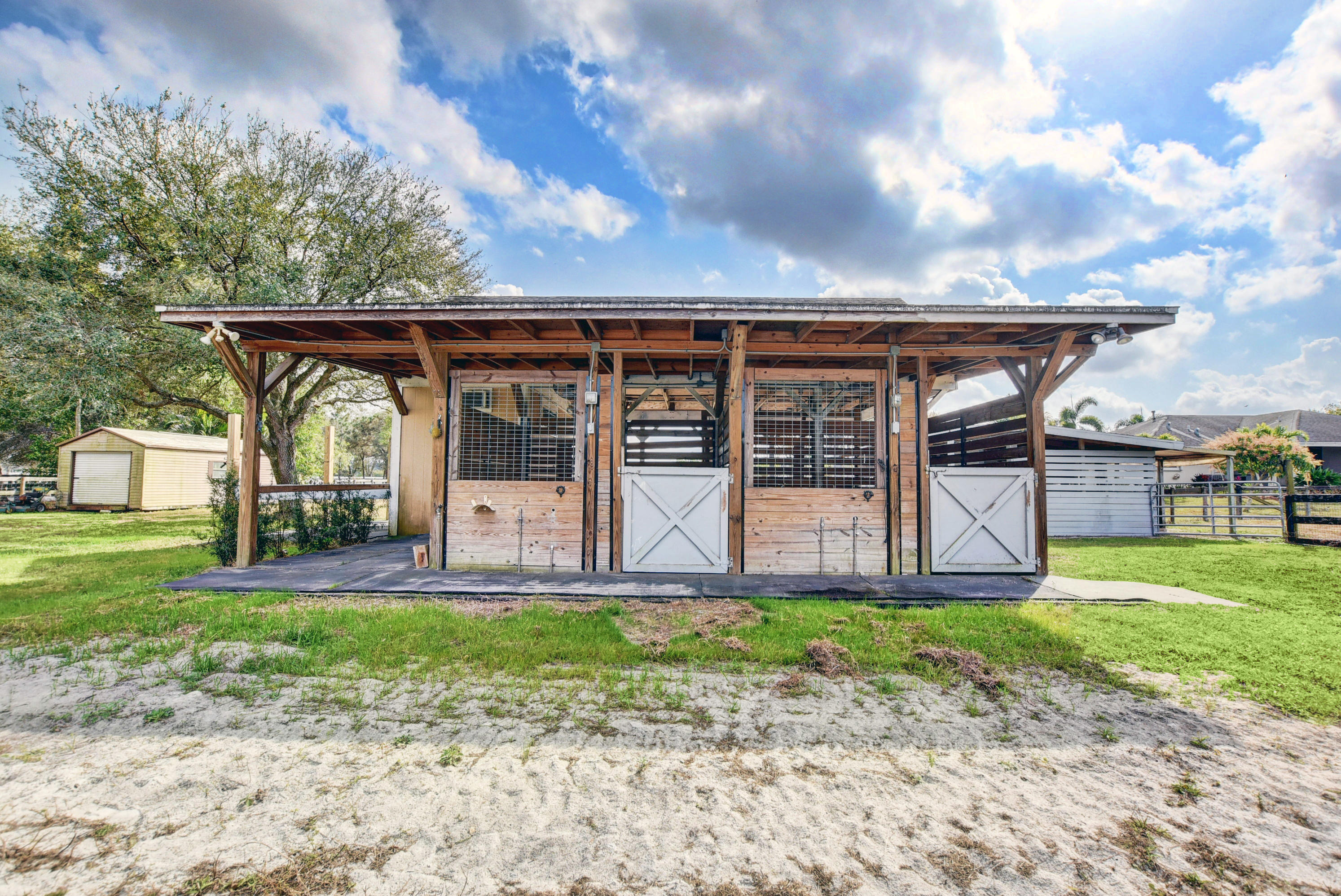 16493 Rustic Road Wellington, FL 33470 - Photo 45 of 57 a front view of a house with a garden and yard