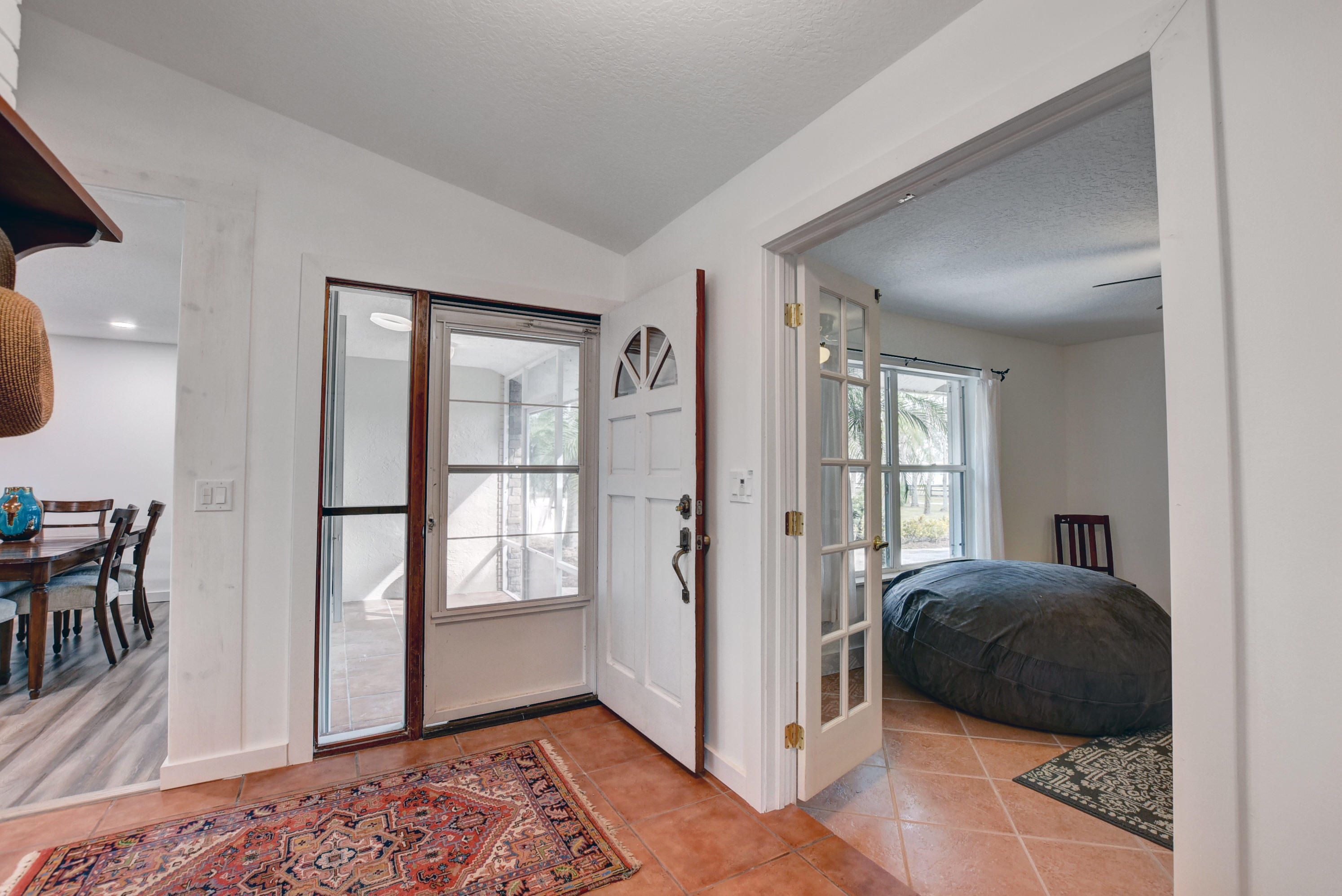 16493 Rustic Road Wellington, FL 33470 - Photo 5 of 57 a bedroom with a bed and wooden floor