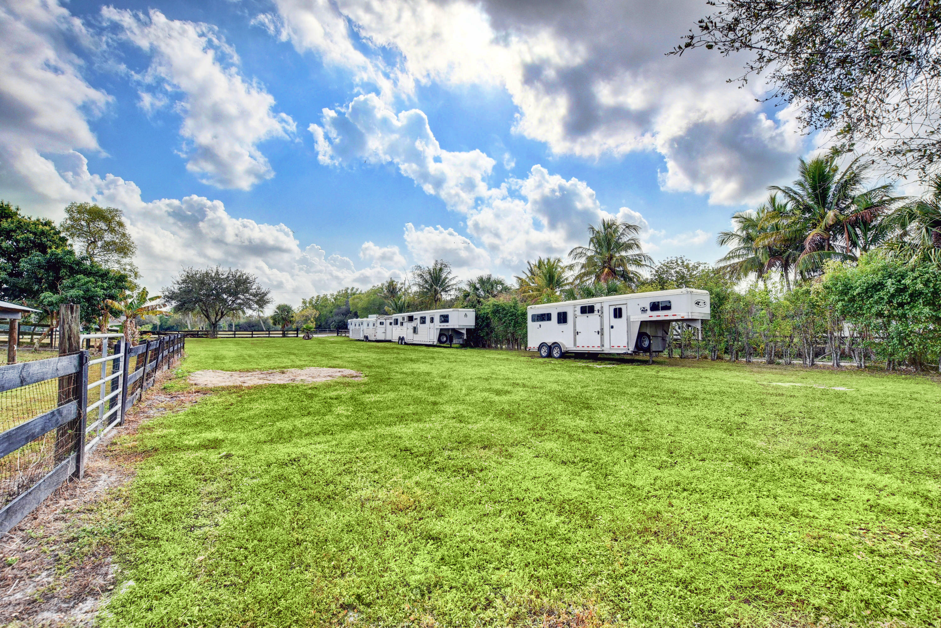 16493 Rustic Road Wellington, FL 33470 - Photo 52 of 57 a view of a house with a big yard next to a big yard