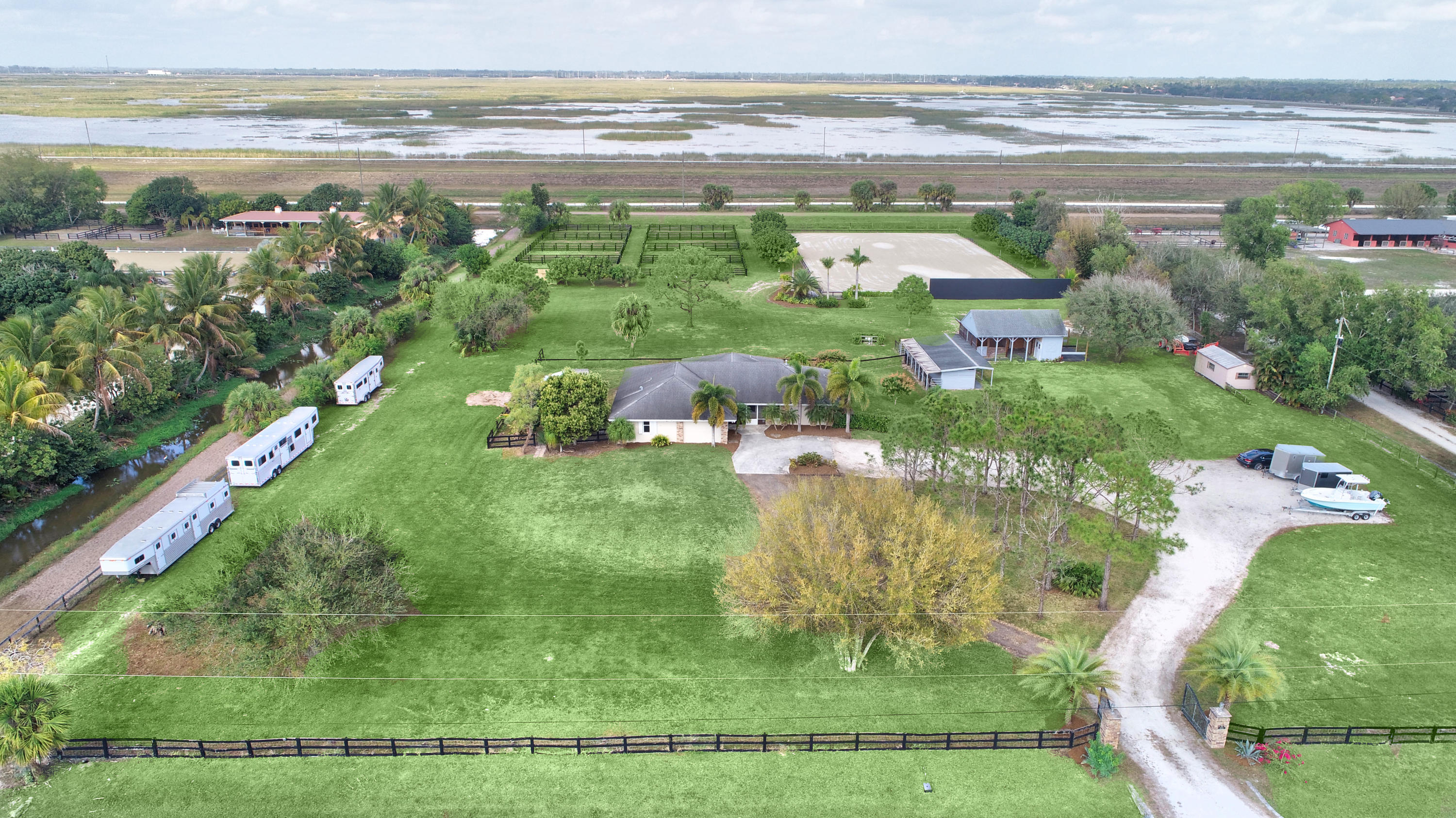 16493 Rustic Road Wellington, FL 33470 - Photo 54 of 57 a view of a lake with a big yard