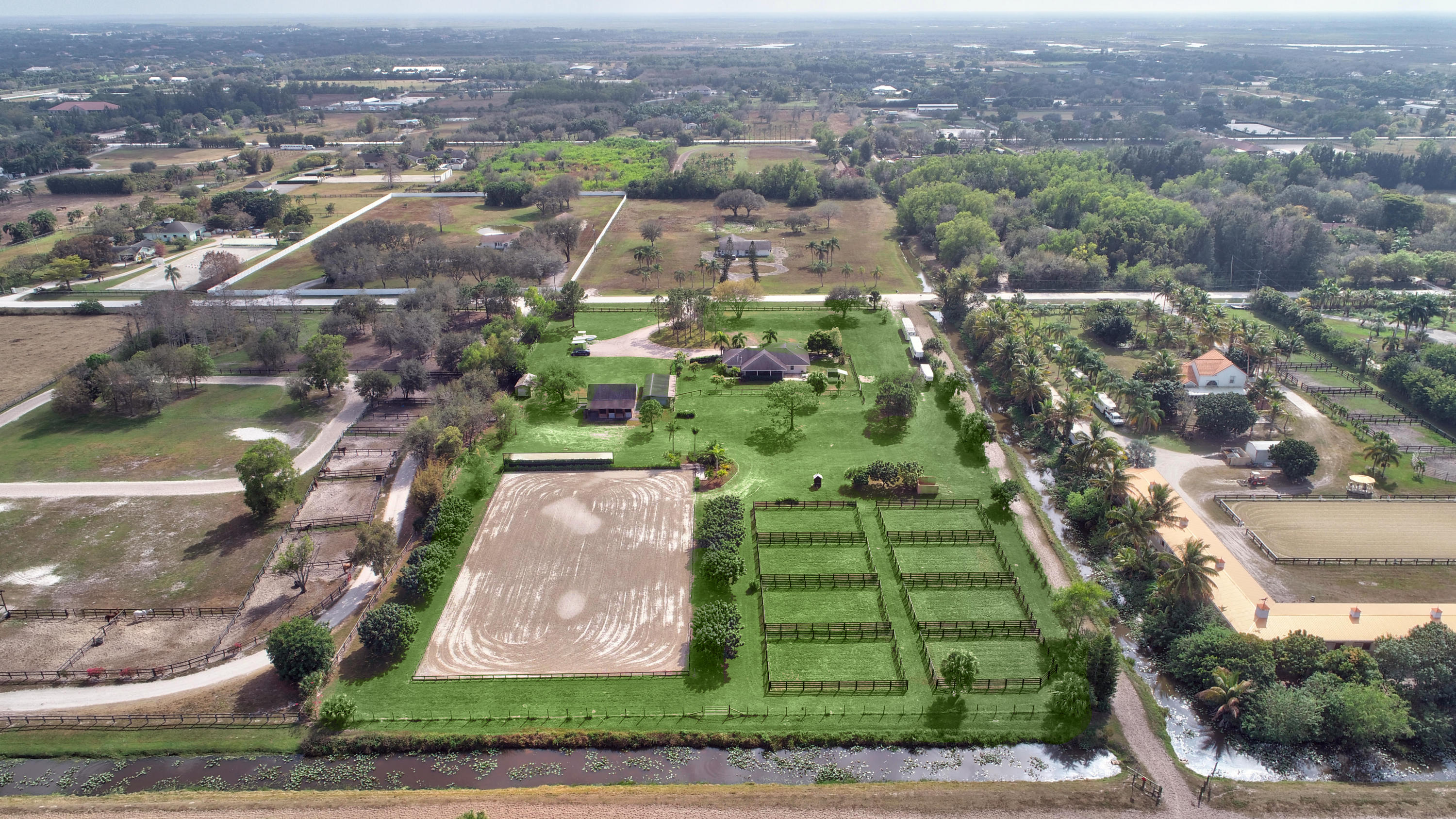 16493 Rustic Road Wellington, FL 33470 - Photo 56 of 57 an aerial view of residential houses with outdoor space and trees