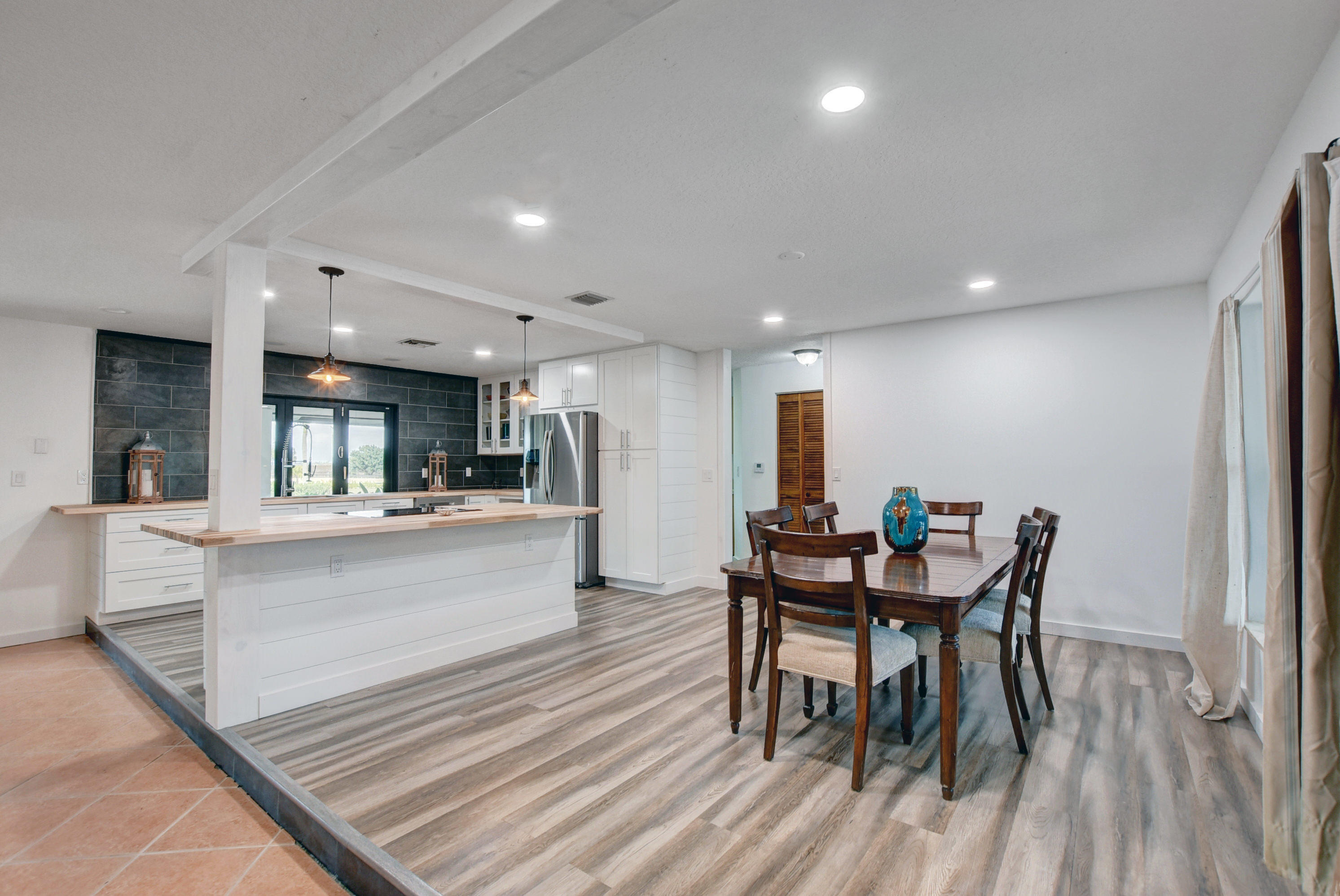16493 Rustic Road Wellington, FL 33470 - Photo 6 of 57 a view of a dining room with furniture and wooden floor