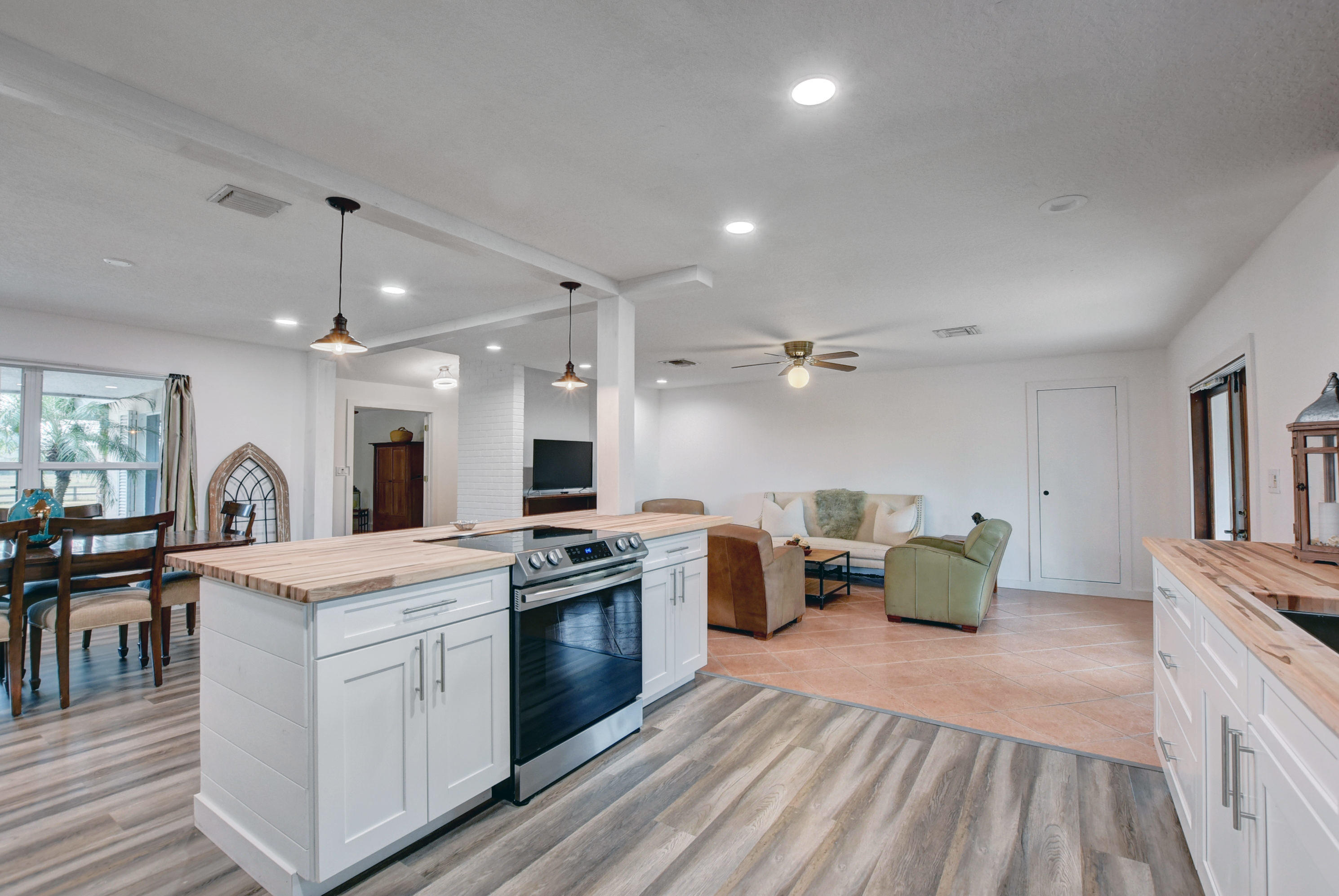 16493 Rustic Road Wellington, FL 33470 - Photo 9 of 57 a kitchen that has a lot of white cabinets and stainless steel appliances