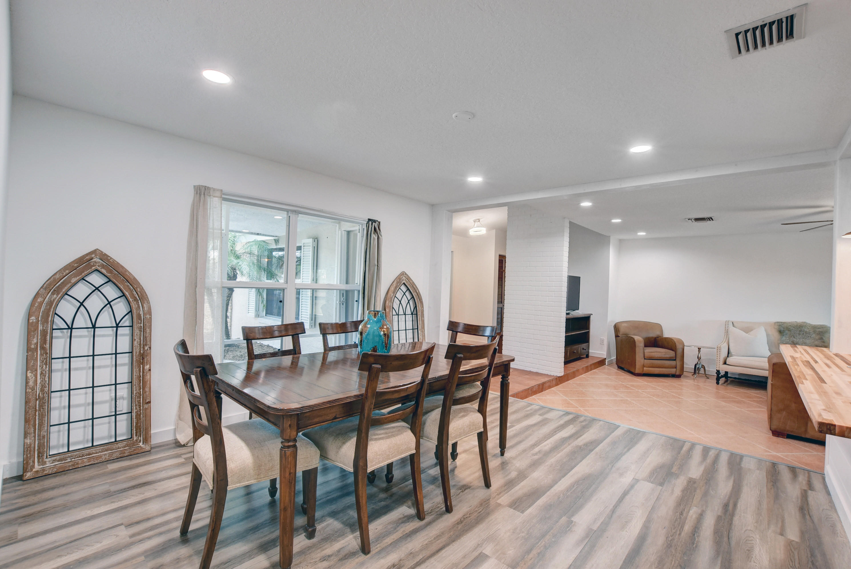 16493 Rustic Road Wellington, FL 33470 - Photo 10 of 57 a view of a dining room with furniture window and wooden floor