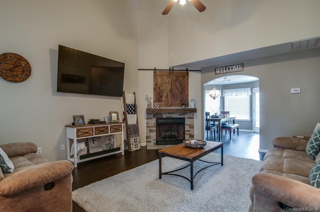 721 Jones Branch Road, Unit 75 Fort Mill, SC 29715 - Photo 11 of 36 a living room with furniture a fireplace and a flat screen tv