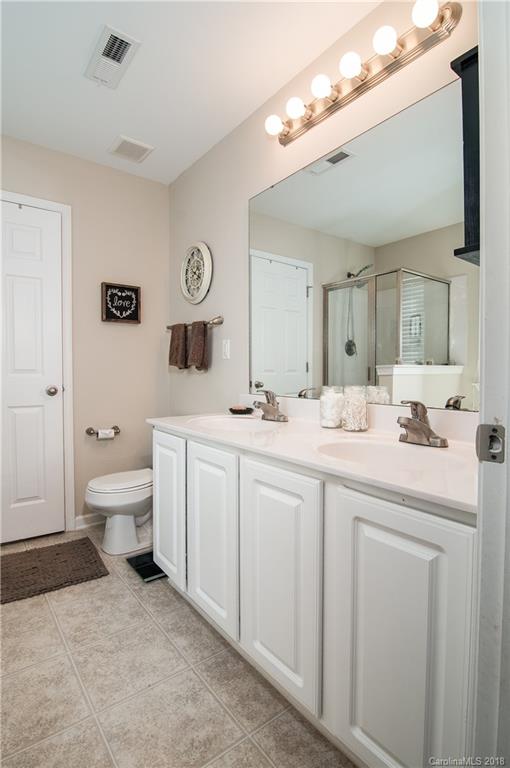 721 Jones Branch Road, Unit 75 Fort Mill, SC 29715 - Photo 24 of 36 a bathroom with a toilet a sink a mirror and a window