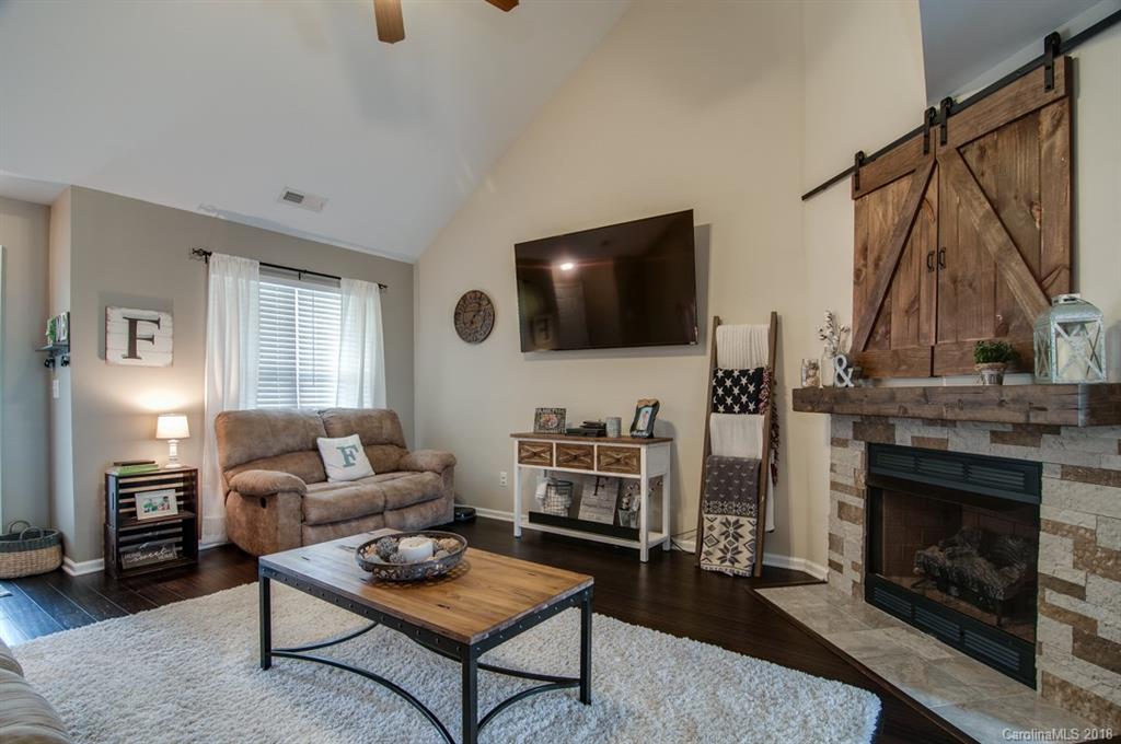 721 Jones Branch Road, Unit 75 Fort Mill, SC 29715 - Photo 6 of 36 a living room with furniture a fireplace and a flat screen tv