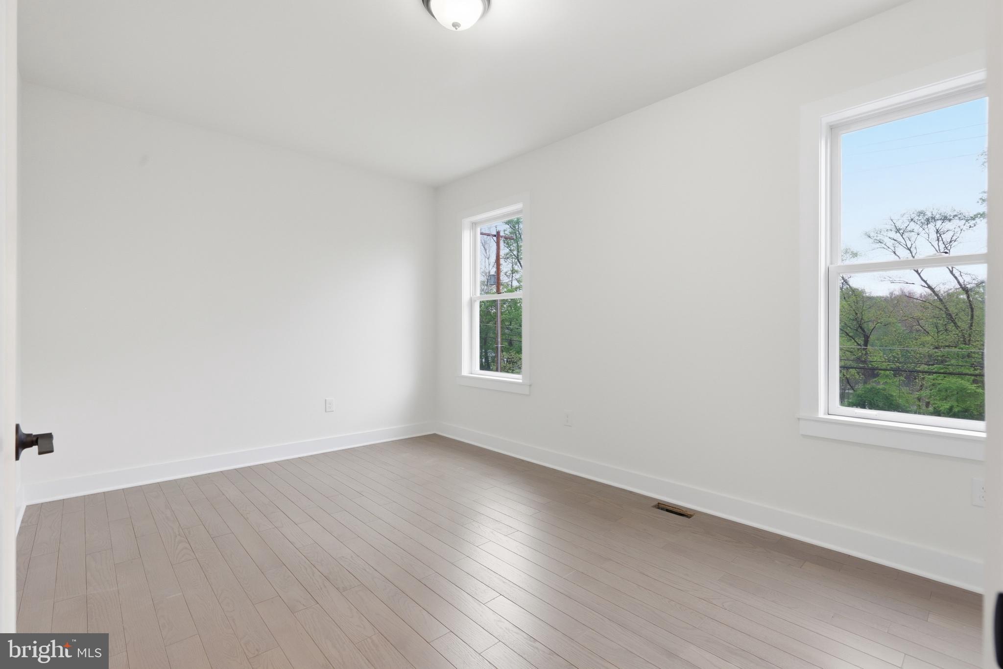 759 River Road Erwinna, PA 18920 - Photo 24 of 46 an empty room with wooden floor and windows