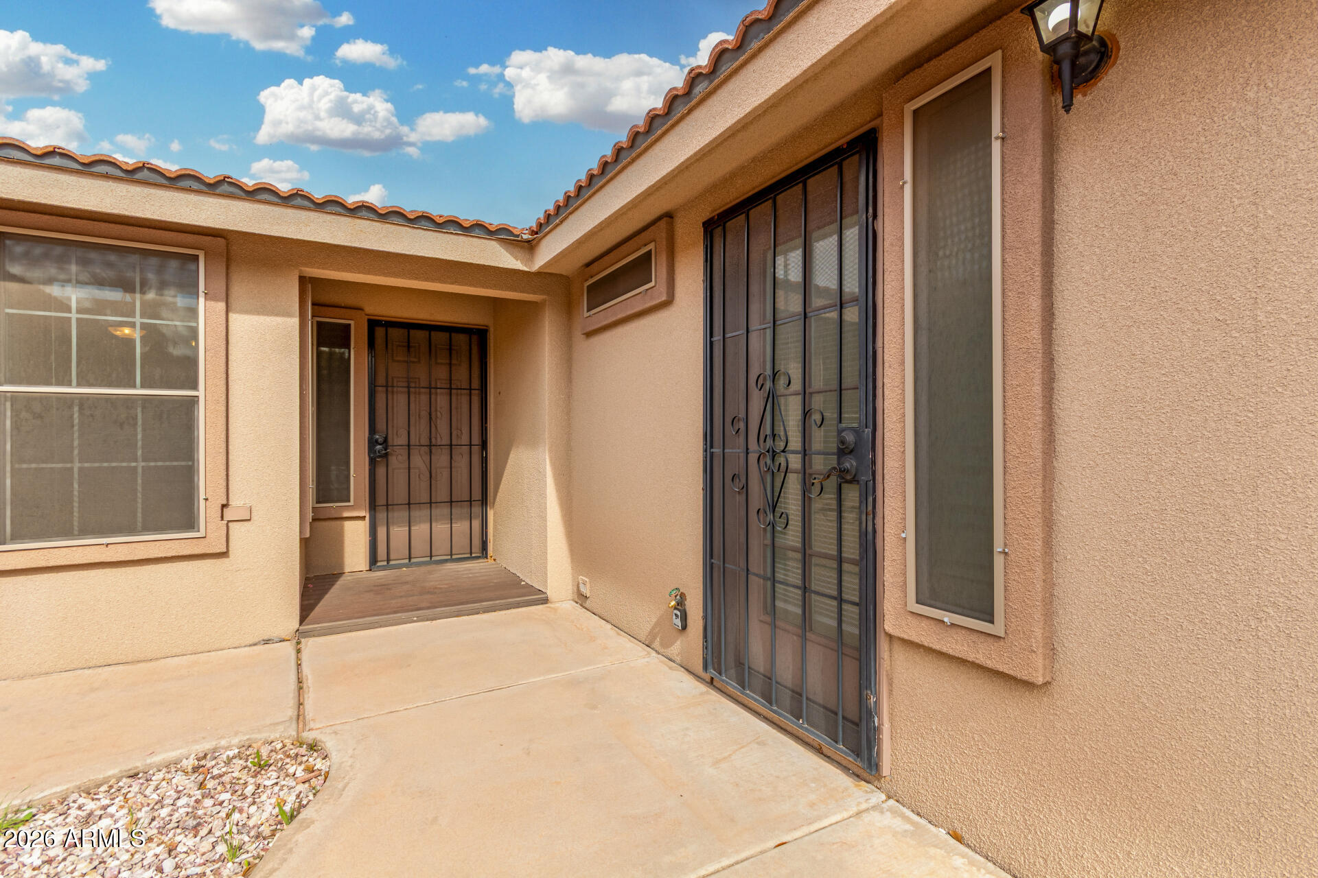 3301 South Goldfield Road, Unit 3004 Apache Junction, AZ 85119 - Photo 4 of 67 a view of a brick house with a large window