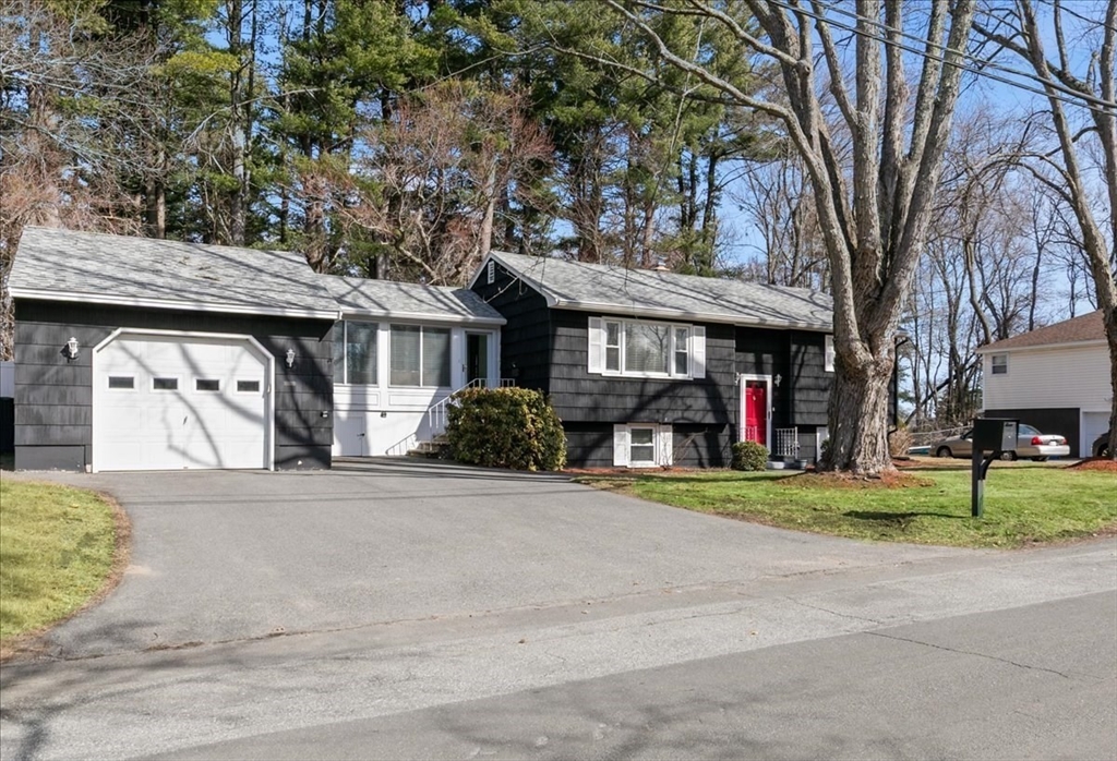 58 Oakcrest Circle Methuen, MA 01844 - Photo 39 of 41 a front view of a house with a yard and potted plants