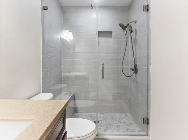 a view of a hallway with wooden floor and a chandelier