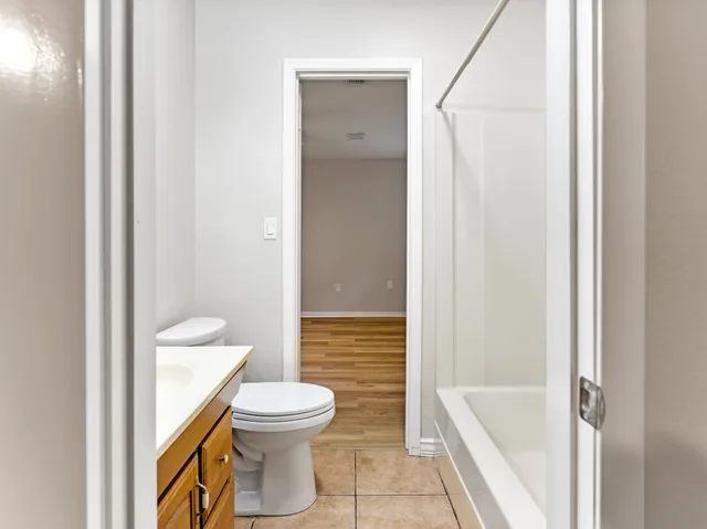 a bathroom with a bath tub sink shower and mirror