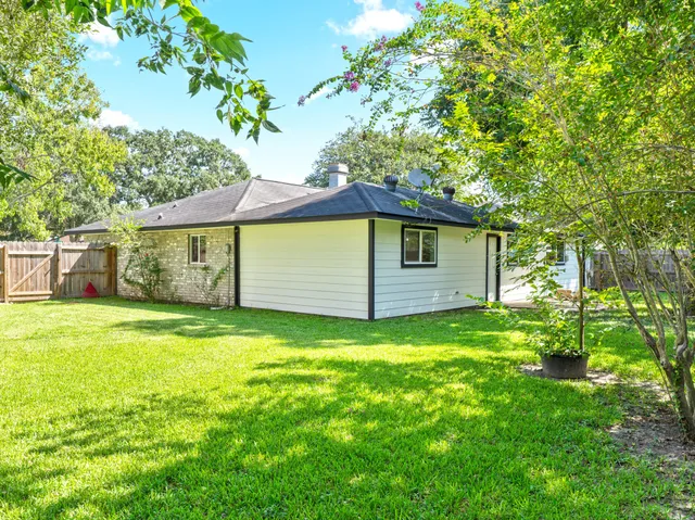 a view of a backyard with large trees