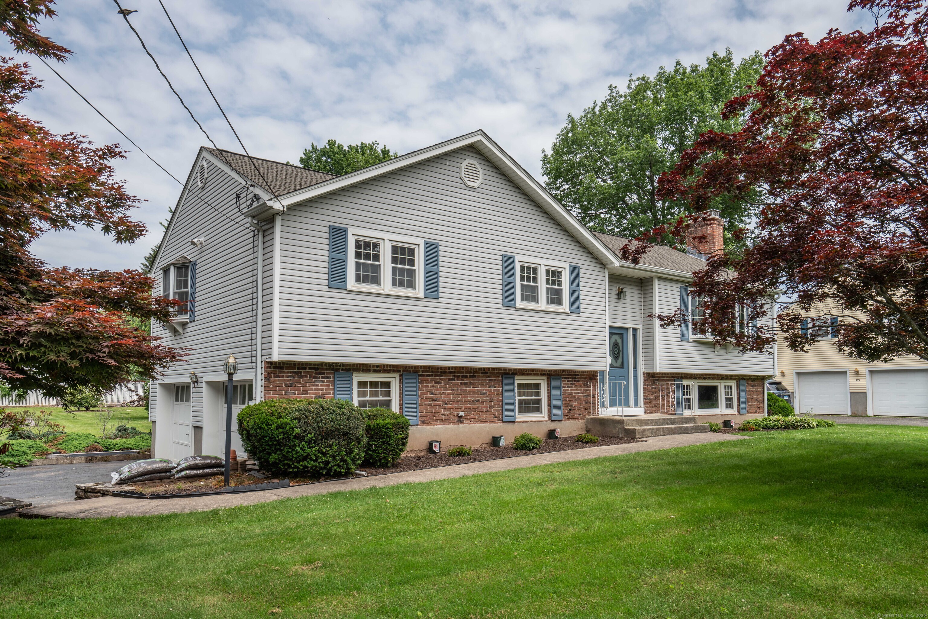 a front view of house with yard and green space
