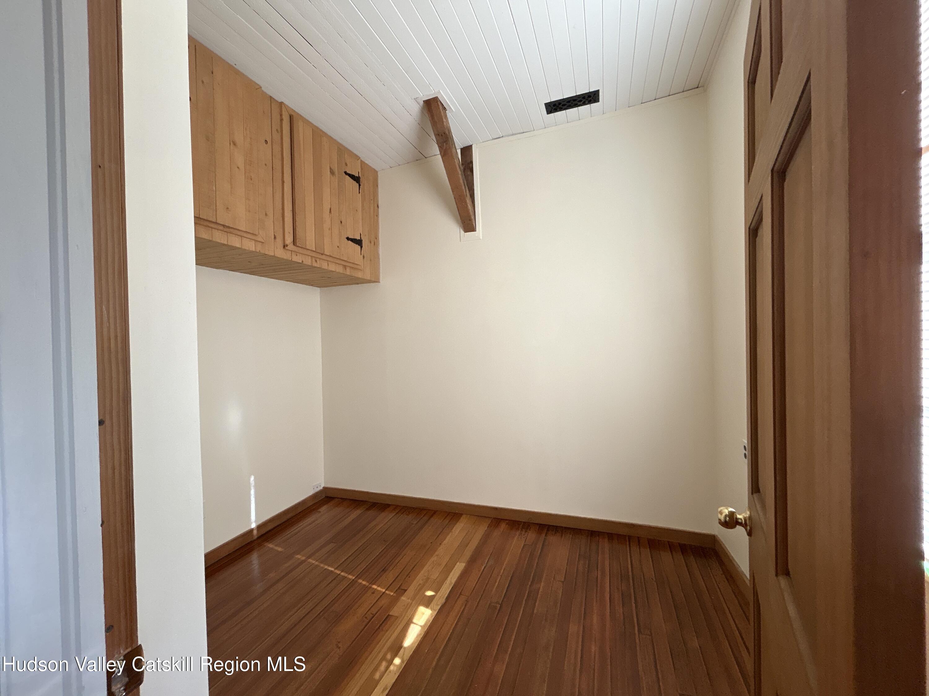 135 Rudd Pond Road Millerton, NY 12546 - Photo 5 of 10 a view of an empty room with wooden floor and a window