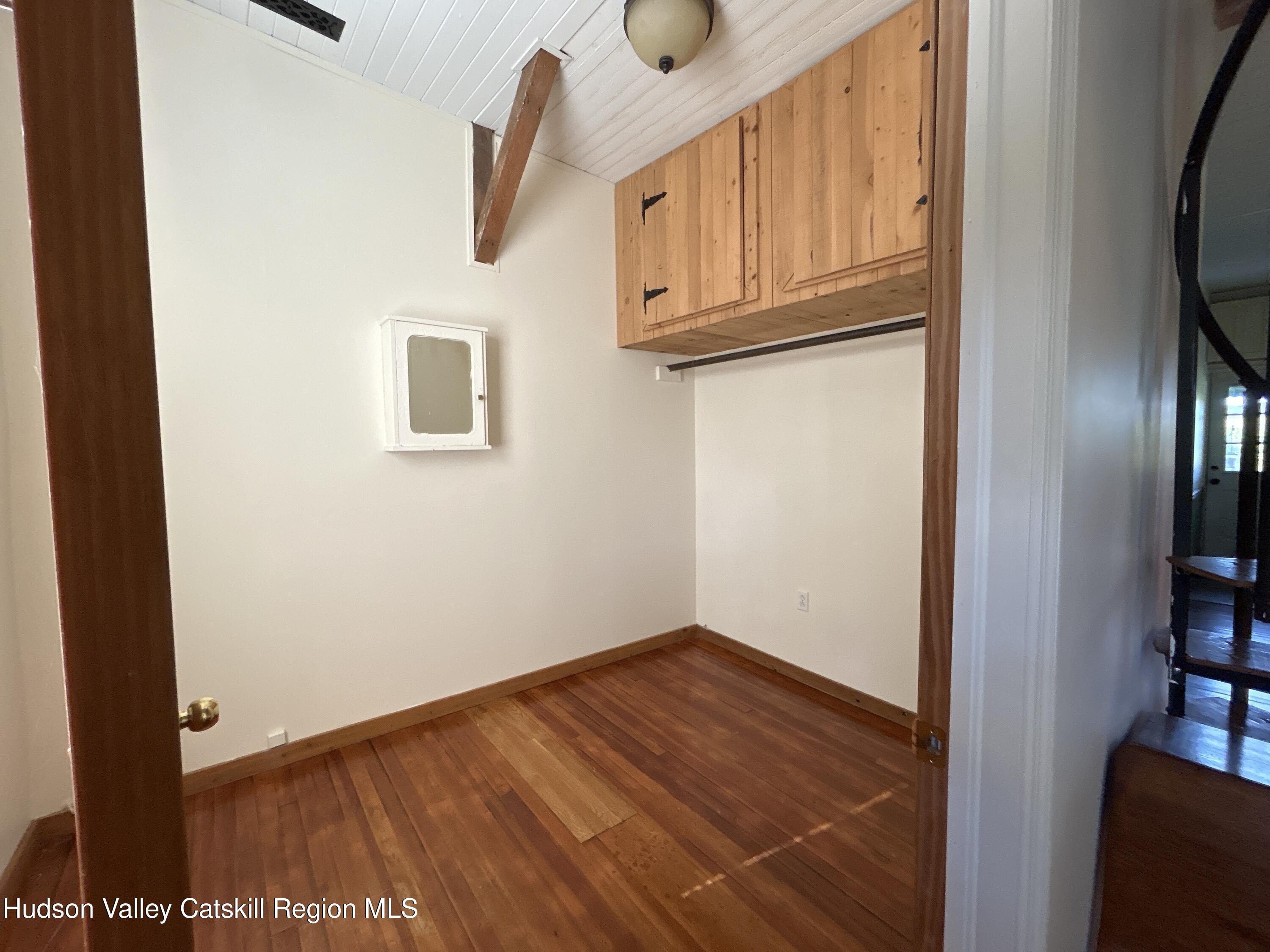 135 Rudd Pond Road Millerton, NY 12546 - Photo 6 of 10 a view of a livingroom with wooden floor and wardrobe
