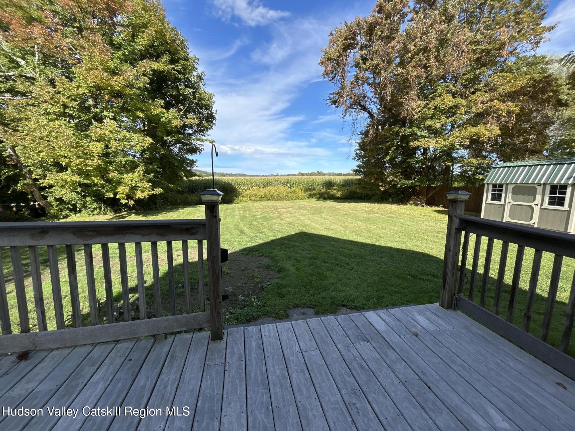135 Rudd Pond Road Millerton, NY 12546 - Photo 10 of 10 a view of a deck with wooden floor and fence next to a yard