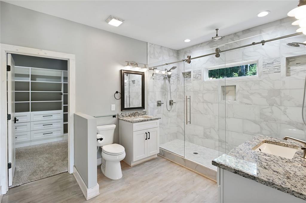 2040 Ridge Road Cumming, GA 30041 - Photo 22 of 52 a bathroom with a granite countertop sink a toilet and shower