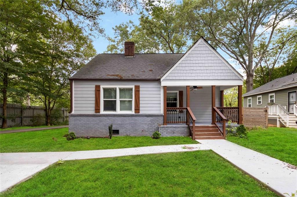 1485 Ryan Street Southwest Atlanta, GA 30310 - Photo 1 of 1 a front view of a house with a yard