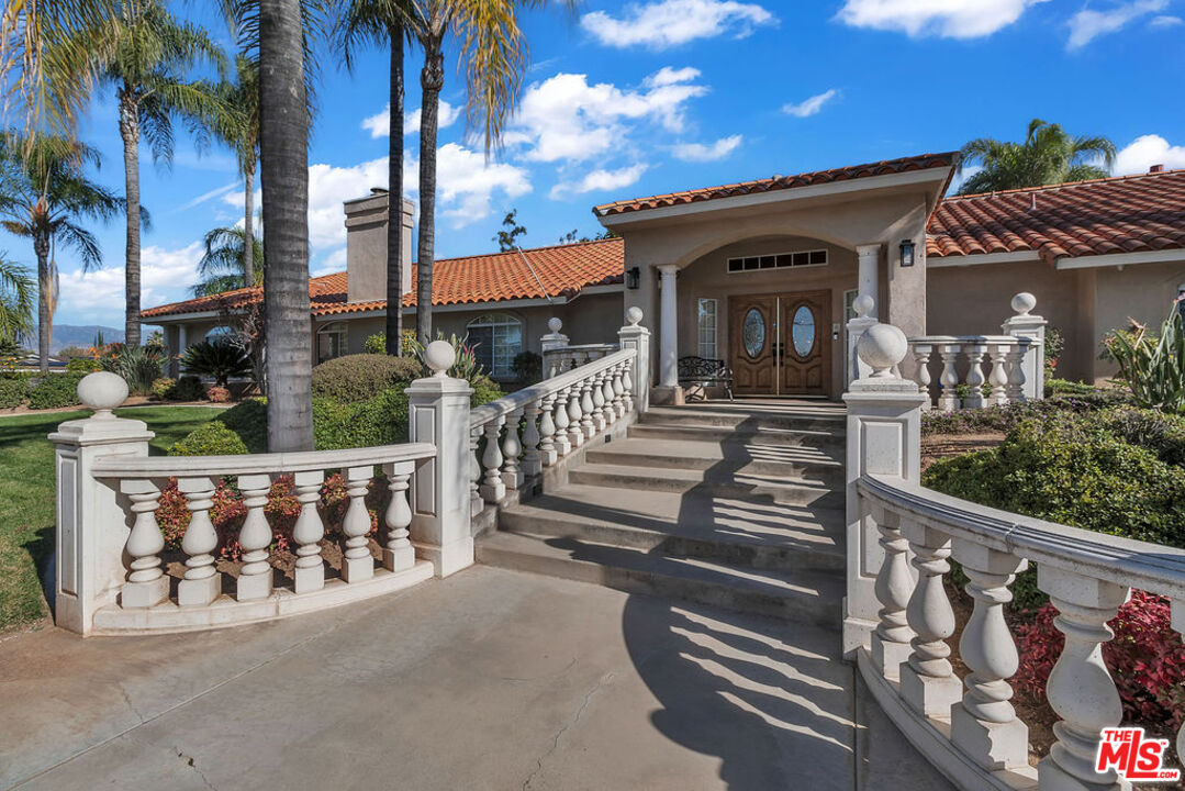 a view of a house with wooden fence