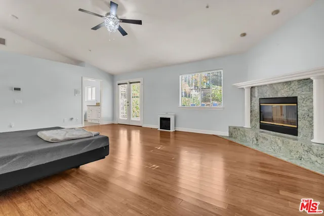 a kitchen with stainless steel appliances kitchen island granite countertop a stove top oven a sink dishwasher a dining table and chairs with wooden floor