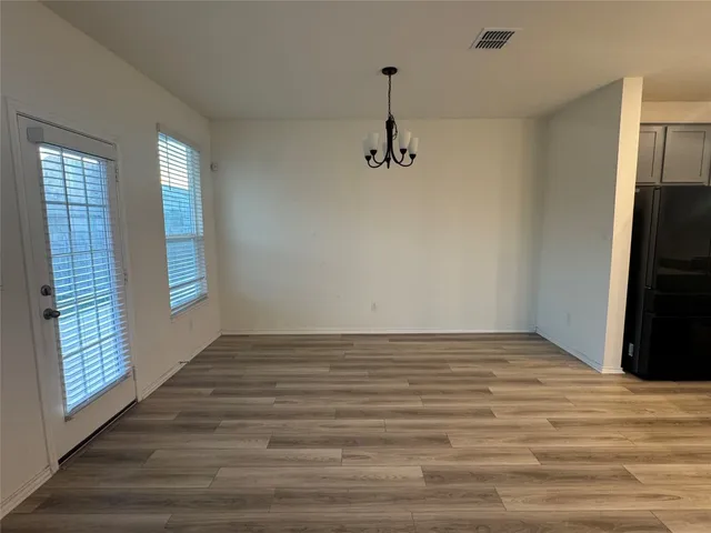 a kitchen with kitchen island a sink appliances and cabinets