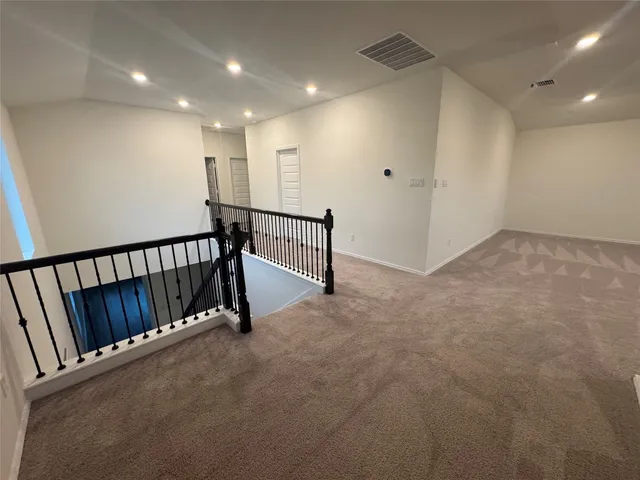 an empty room with a ceiling fan and window