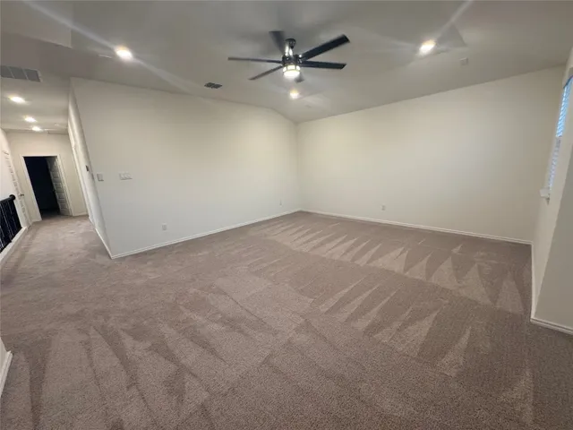 en empty room with windows and fan