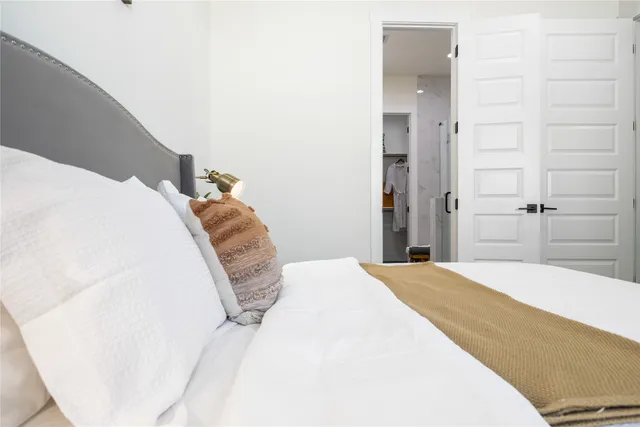 a bedroom with a bed and a mirror