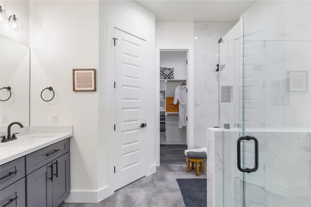 a bathroom with a shower and a sink