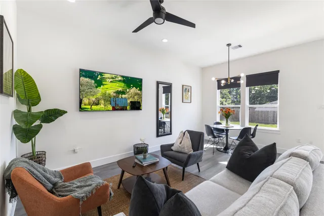a living room with furniture a window and a potted plant
