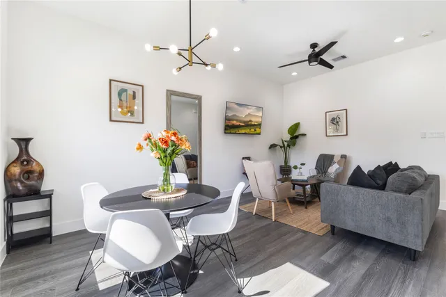 a living room with furniture and a wooden floor