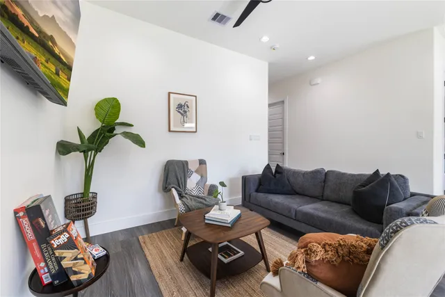 a living room with furniture chess board and a window