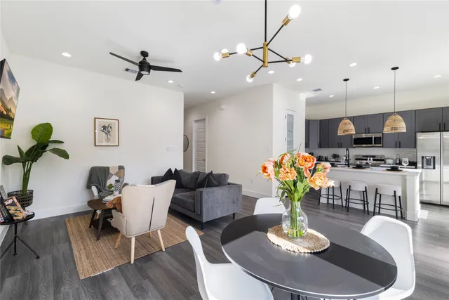 a living room with kitchen island furniture and a wooden floor