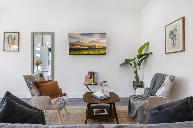 a living room with furniture rug and chair