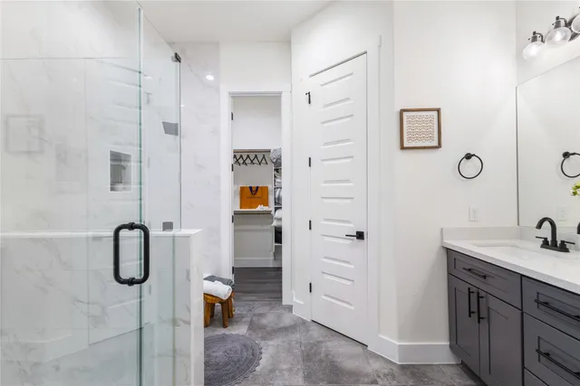 a bathroom with a shower sink and mirror