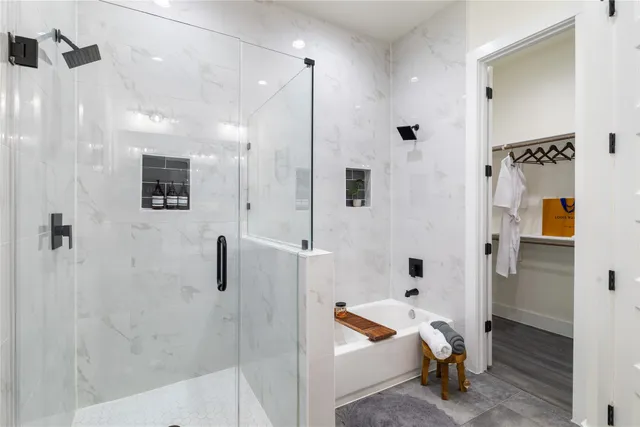 a bathroom with a tub and shower