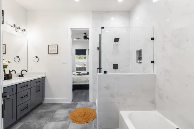 a bathroom with a tub sink and mirror