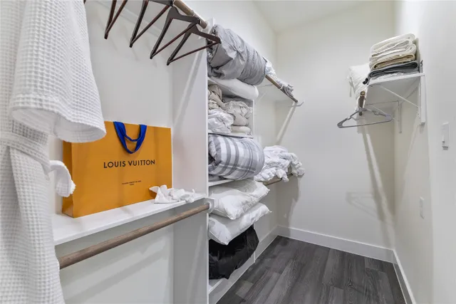 a utility room with a wooden floor and tub