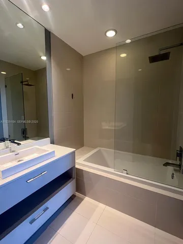 a bathroom with a tub and a sink