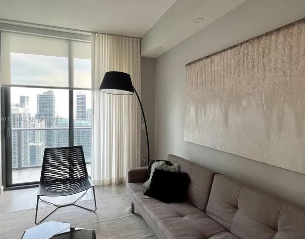 a living room with furniture and a window