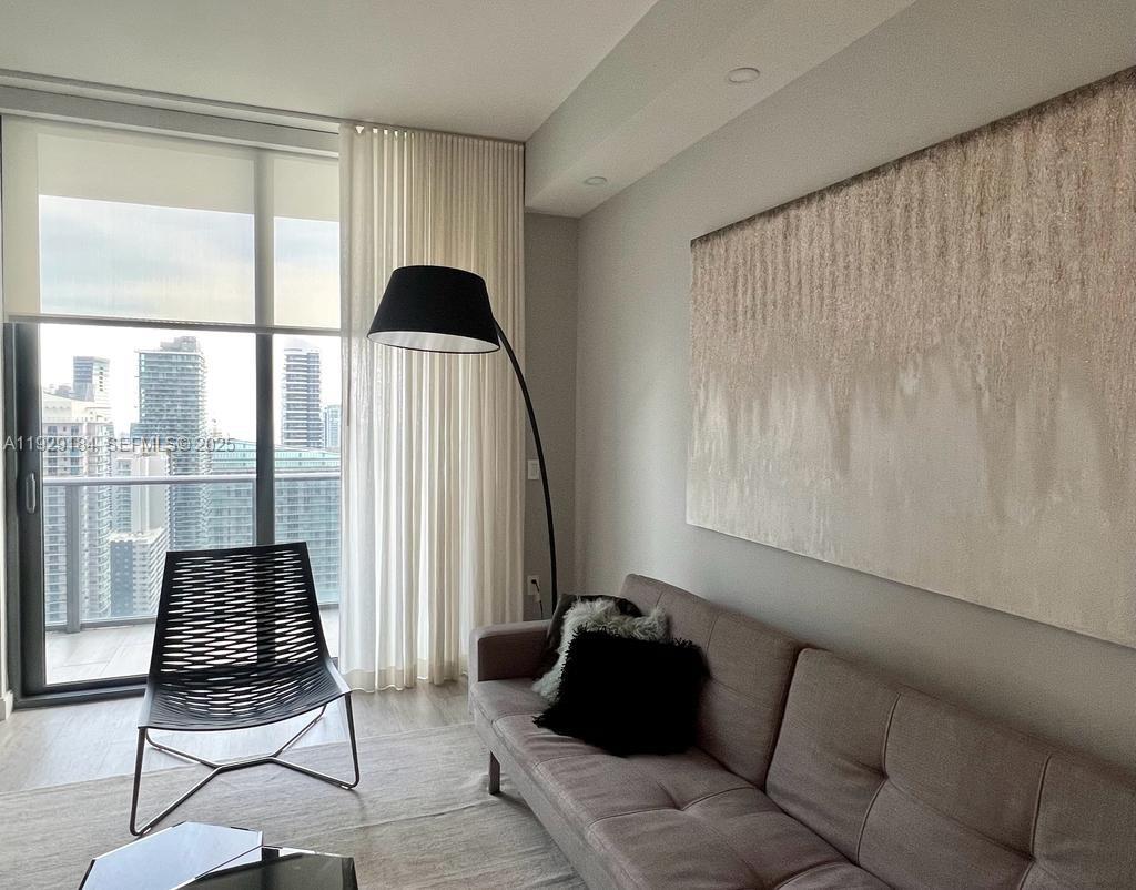 55 Southwest 9th Street, Unit 4205 Miami, FL 33130 - Photo 16 of 37 a living room with furniture and a window