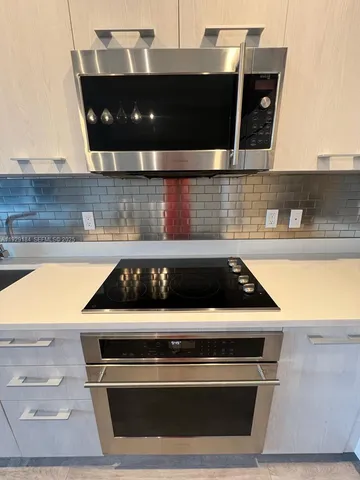 a white stove top oven sitting inside of a kitchen