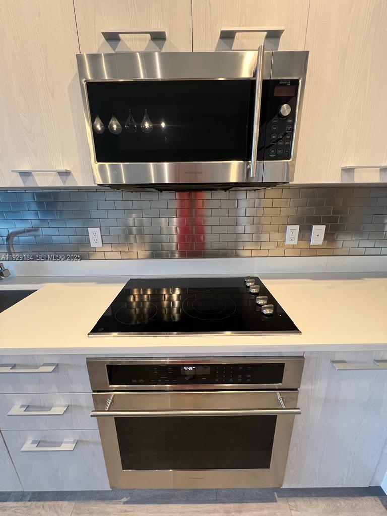 55 Southwest 9th Street, Unit 4205 Miami, FL 33130 - Photo 17 of 37 a white stove top oven sitting inside of a kitchen
