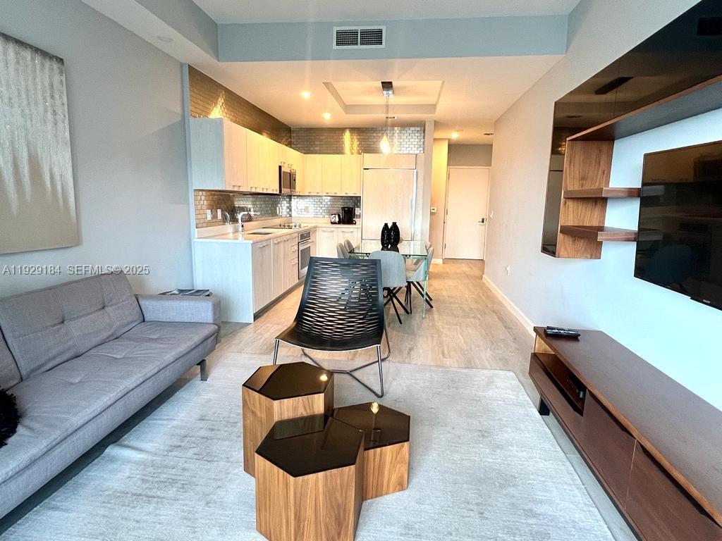 55 Southwest 9th Street, Unit 4205 Miami, FL 33130 - Photo 21 of 37 a living room with furniture and a flat screen tv