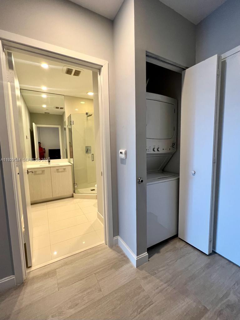55 Southwest 9th Street, Unit 4205 Miami, FL 33130 - Photo 24 of 37 a view of a hallway with a kitchen and a sink