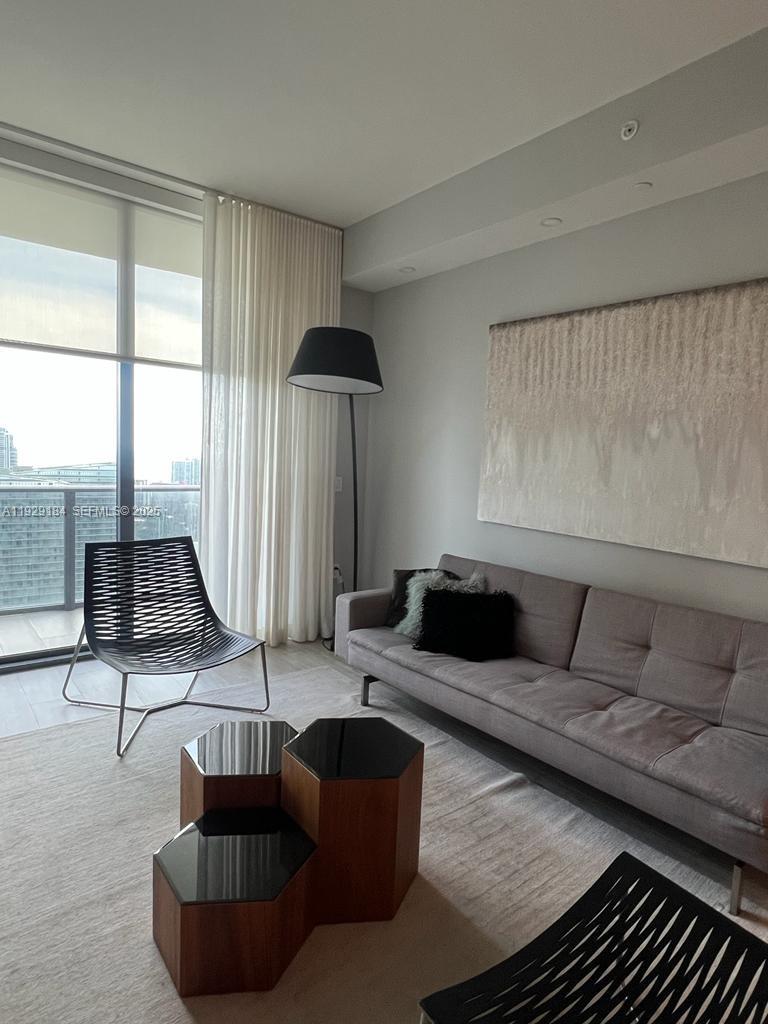 55 Southwest 9th Street, Unit 4205 Miami, FL 33130 - Photo 36 of 37 a living room with furniture and a large window